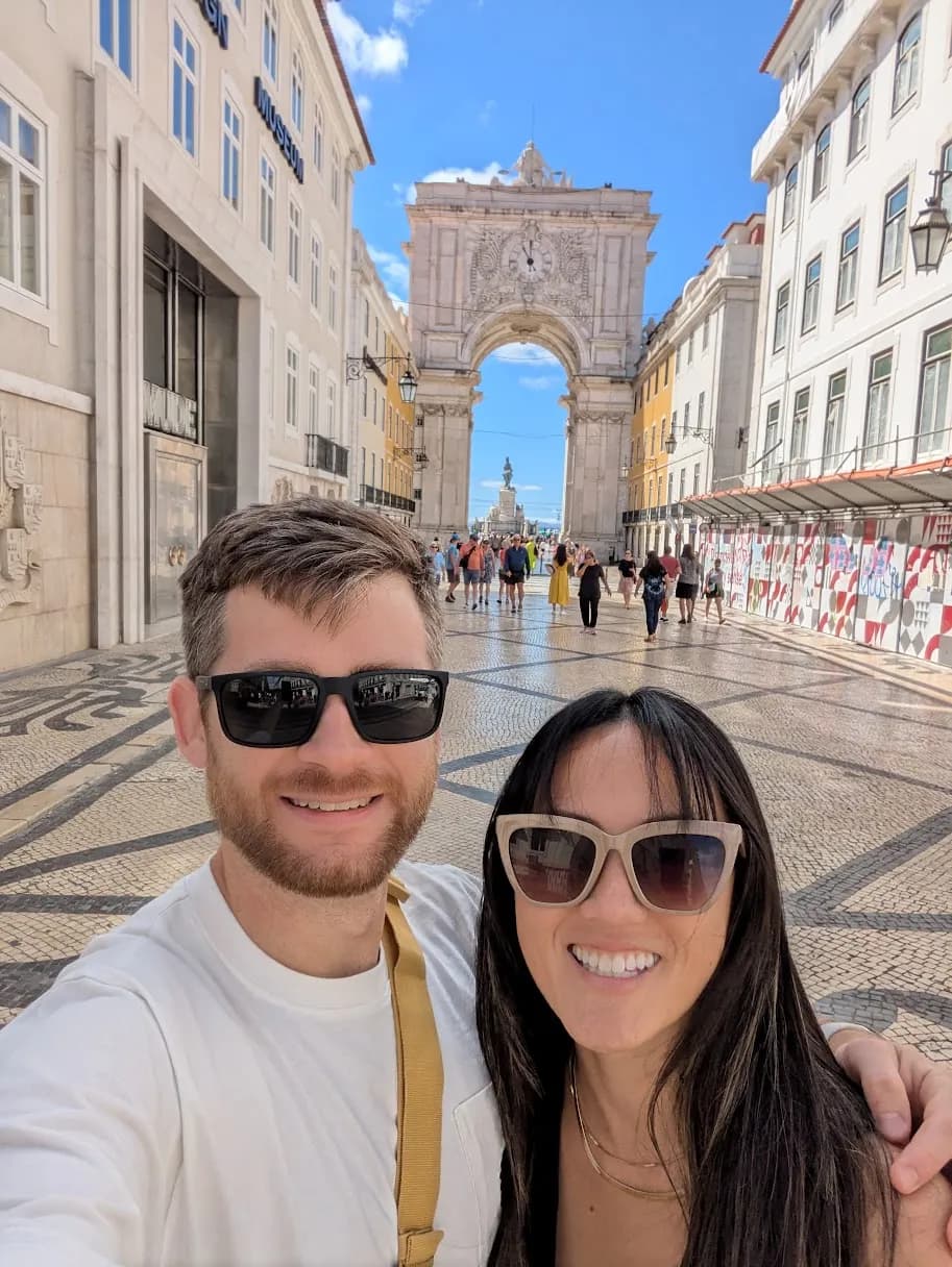 My wife and me on Rua Augusta in Lisbon, the arch behind us